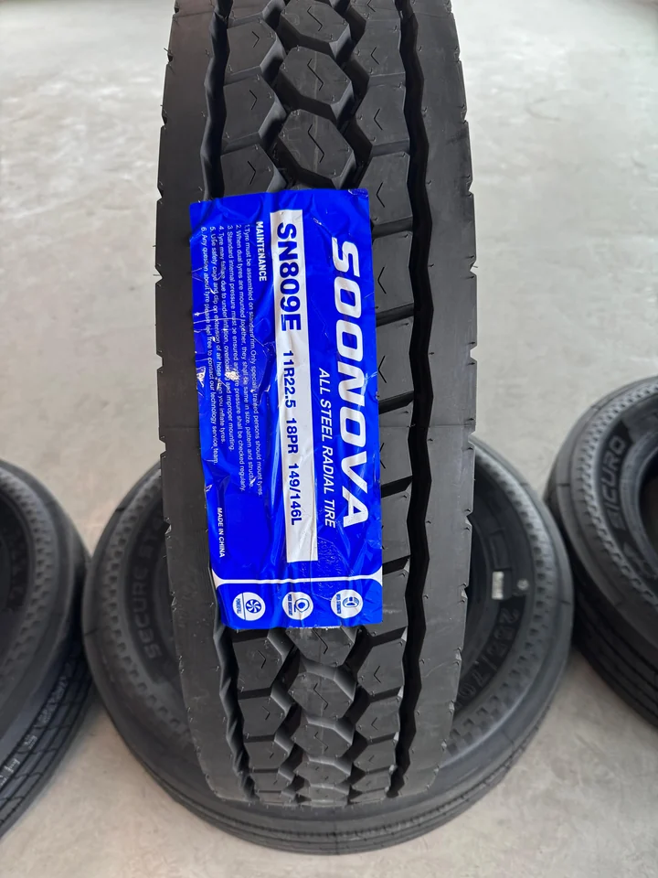 Commercial truck tire with deep tread blocks ready for service